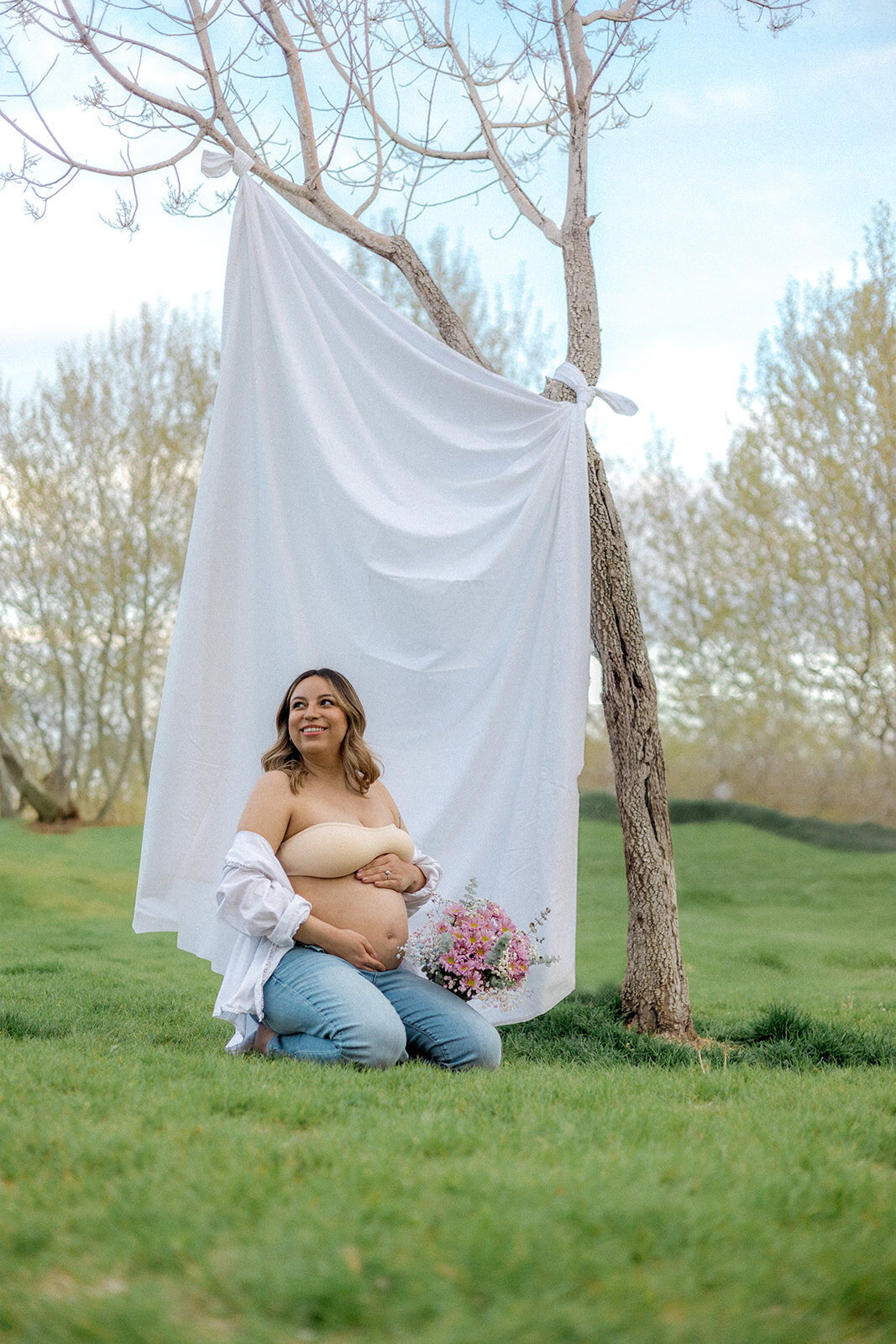 A pregnant woman is happy while holding her belly