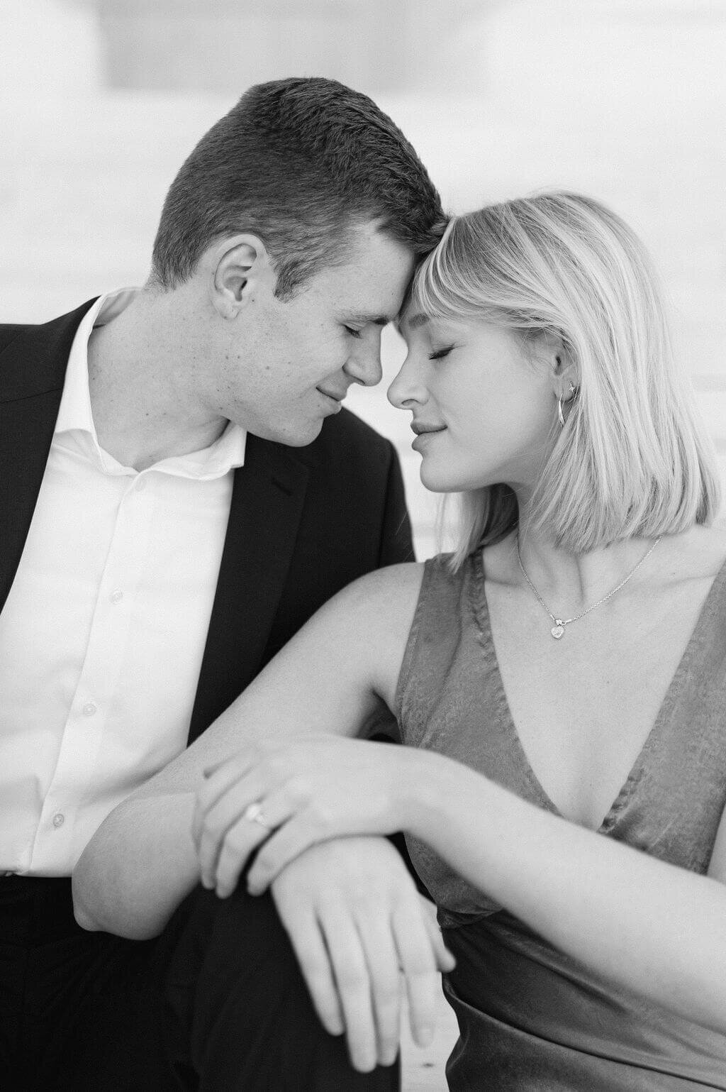 Gorgeous black and white image of a couple resting their foreheads together during an engagement session with Rachael Mattio