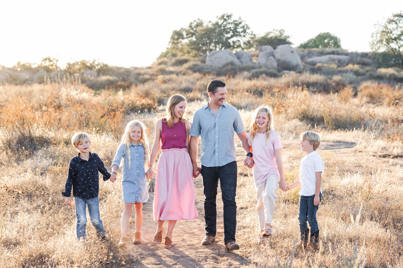 san-diego-family-portrait-family-walking-in-family-of-four-sitting-on-rock-wrights-field-san-diego