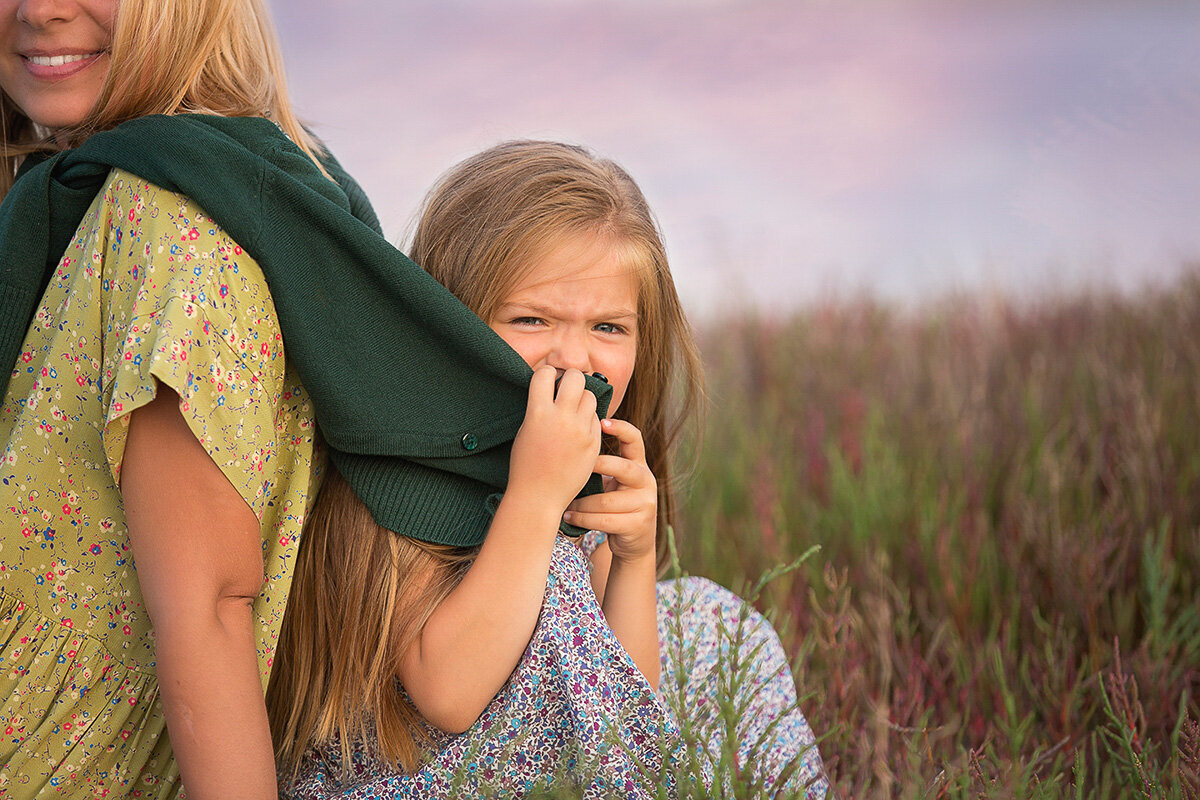 Girl by mom's shoulder
