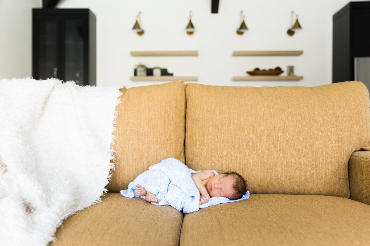 sleeping newborn baby on couch