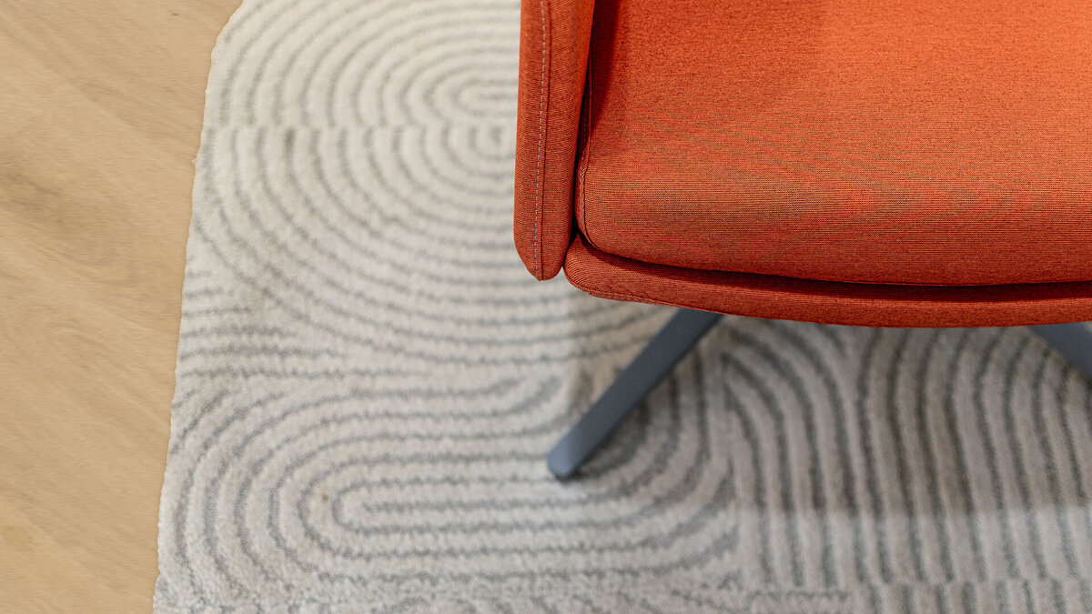 orange-chair-curved-rug-detail-interior-design