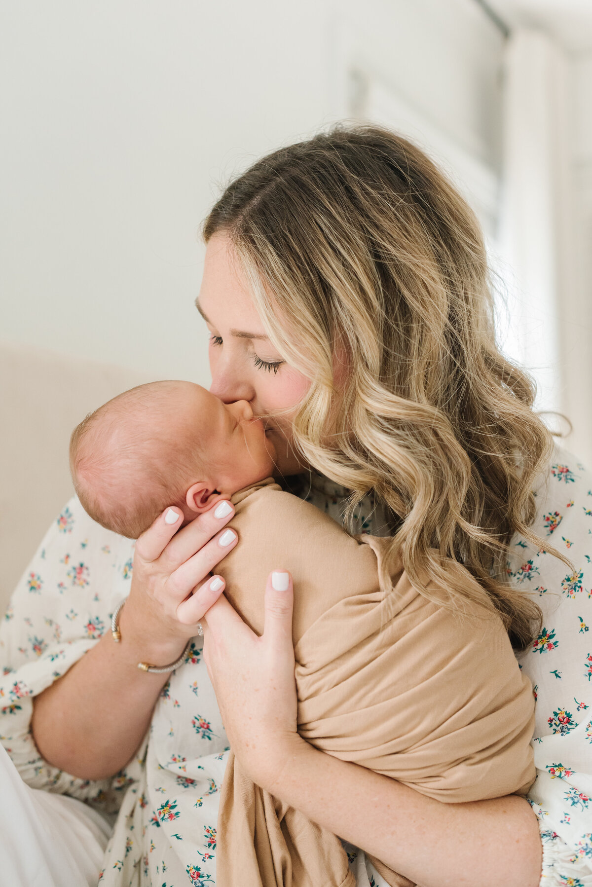 Mom kissing newborn baby on cheek - Northern Virginia Newborn Photographer