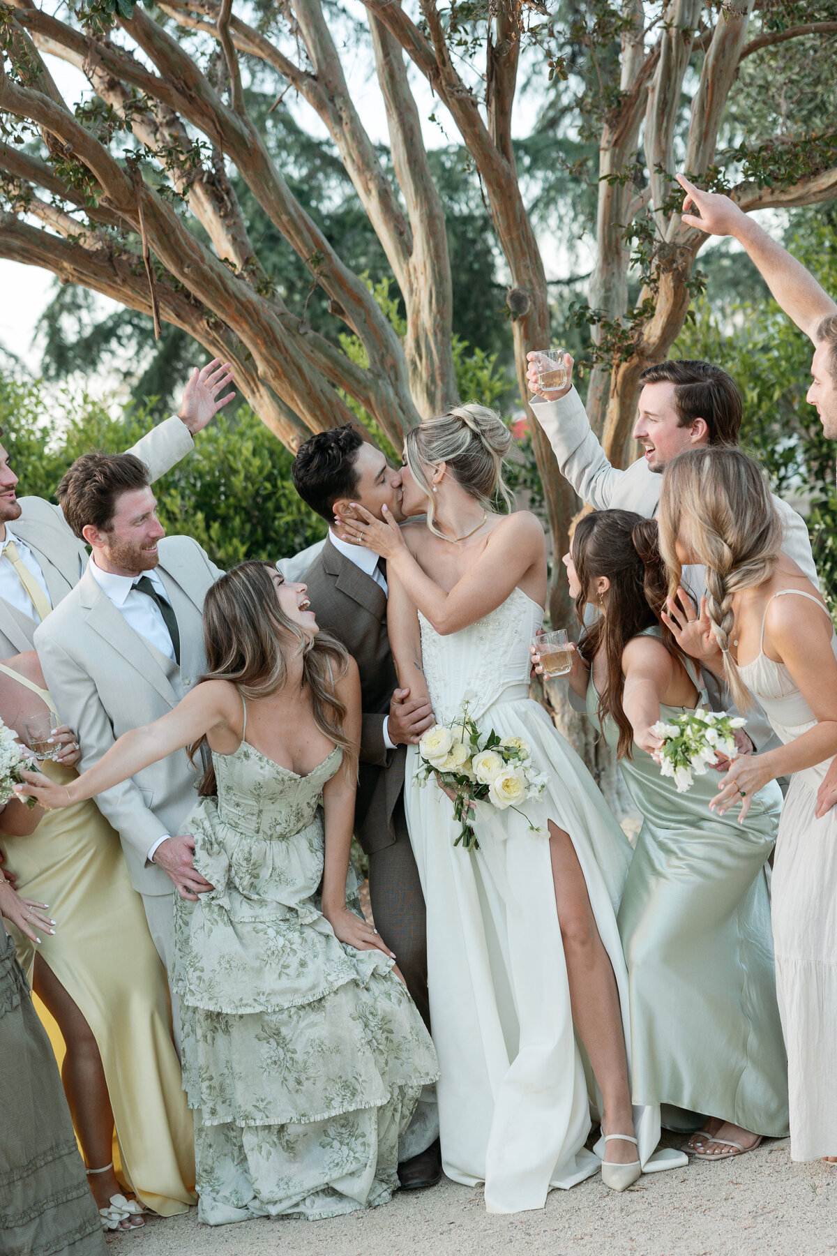 Candid laughter shared between the couple and their wedding party during a fun photo session at a La Jolla wedding venue in Southern California.