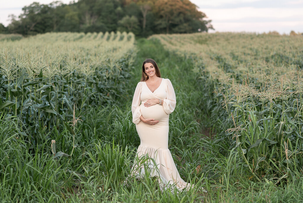 Pregnant mother standing in cornfield at summer maternity session | Sharon Leger Photography | CT Newborn & Family Photographer | Canton, Connecticut