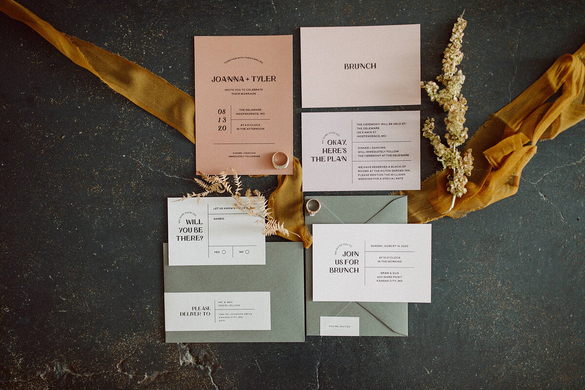 Light pink and white wedding invitations with sage green envelopes