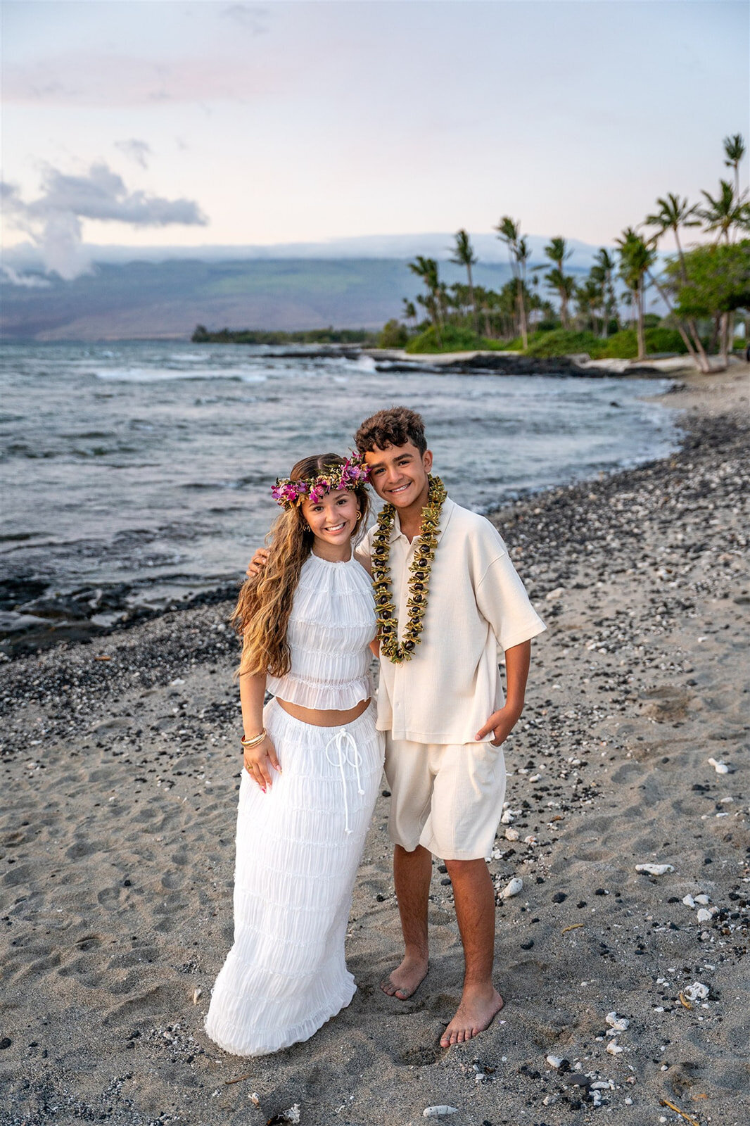 hawaiian family photoshoot with two siblings smiling on the beach