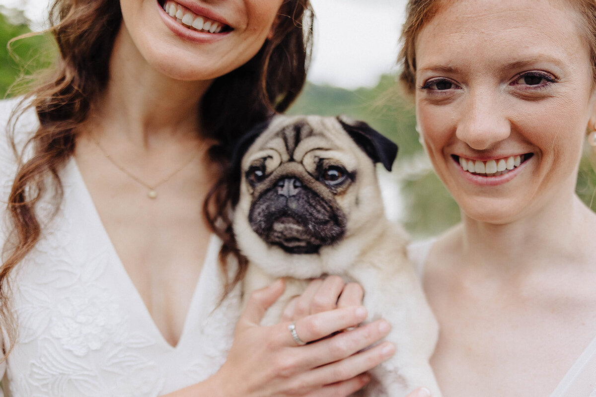Brides with pug dog at Cornell University wedding