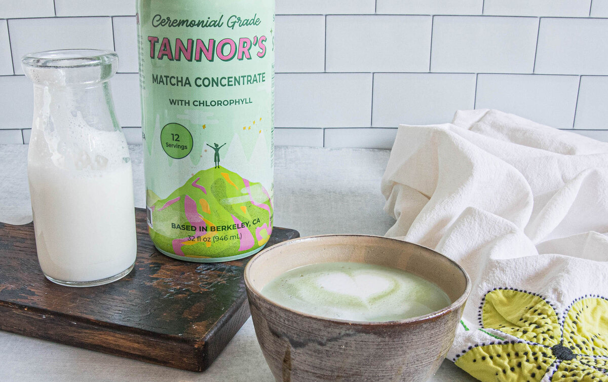 macha tea concentrate as a latte in a handmade ceramic bowl with subway title background as product photography by Nancy Ingersoll