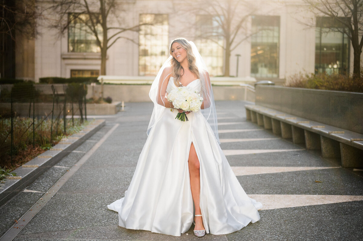 bride who has wedding reception at the omni william penn posing in the sunlight