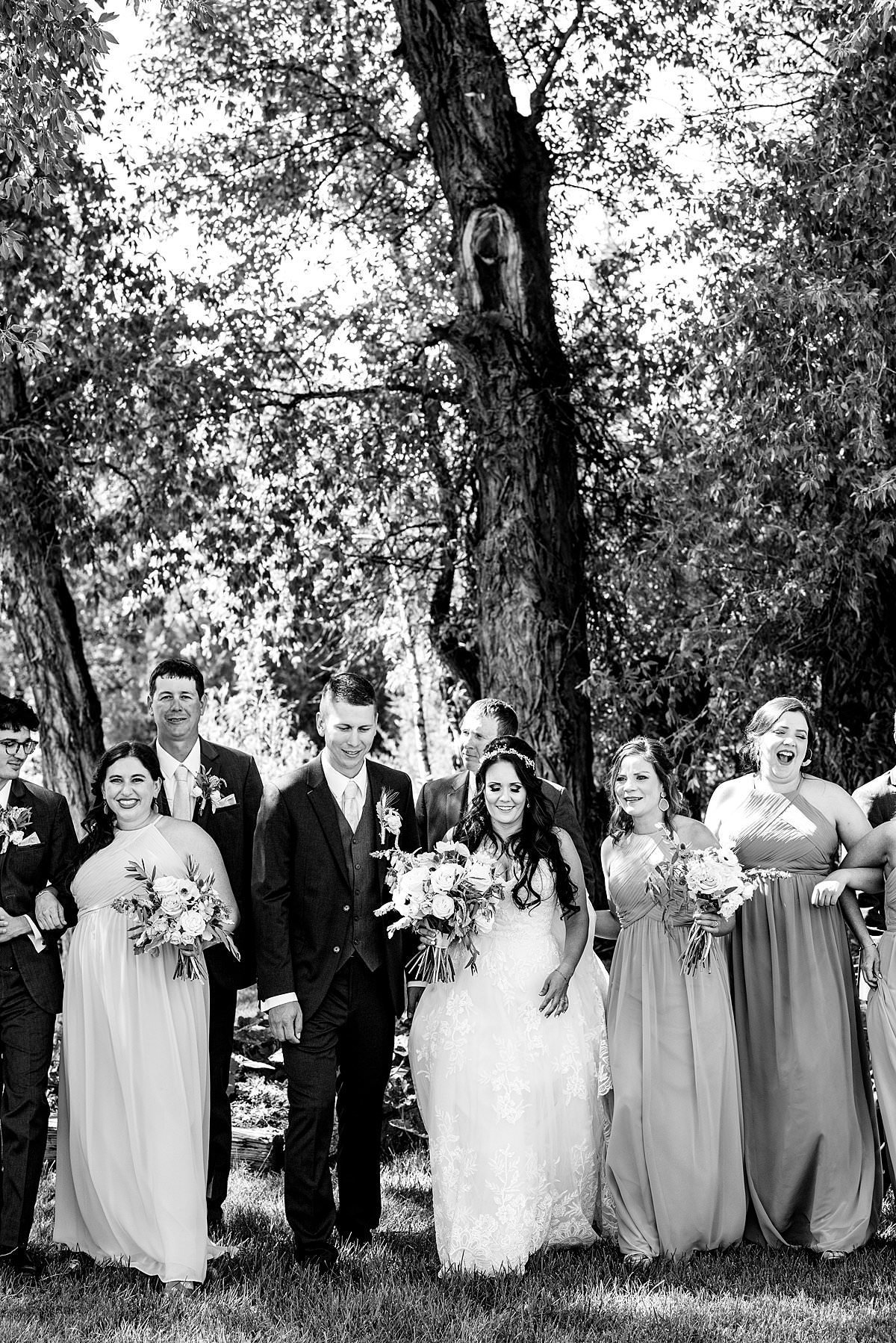 Black and white photo of wedding party walking  together outside