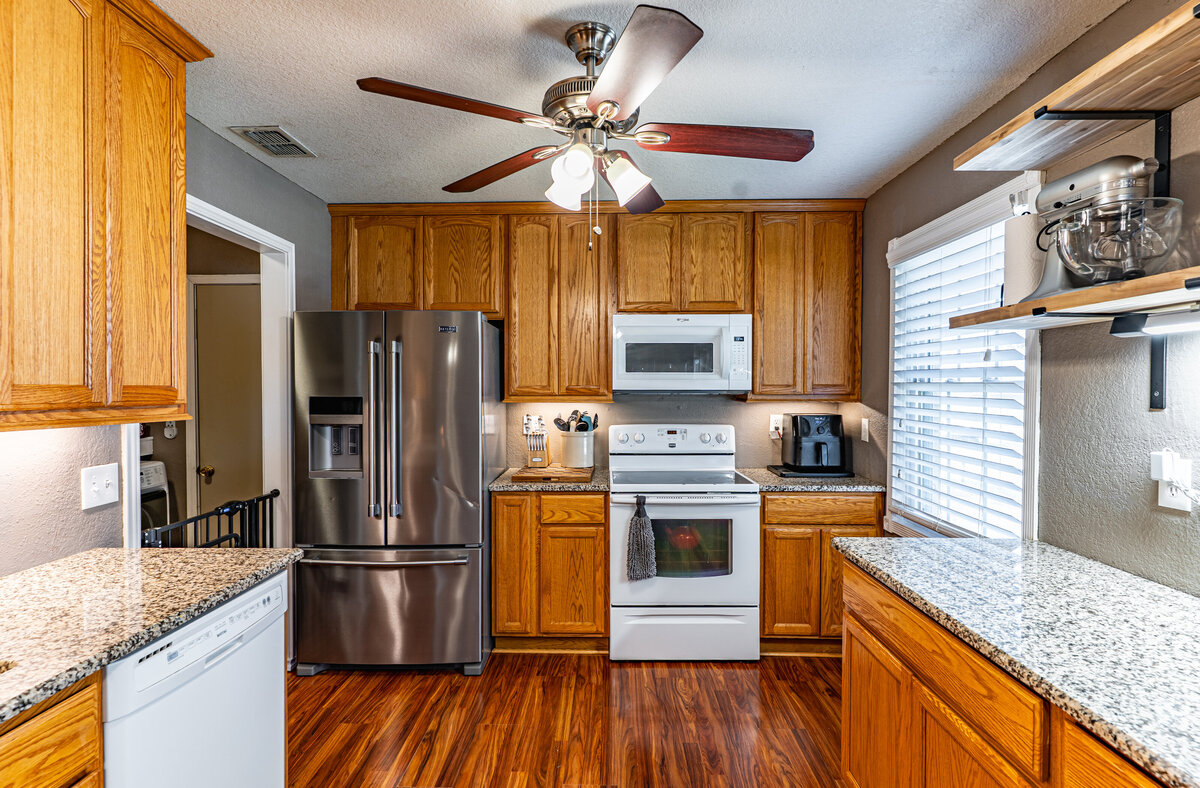 kitchen with granite countertops and under cabinet lighting