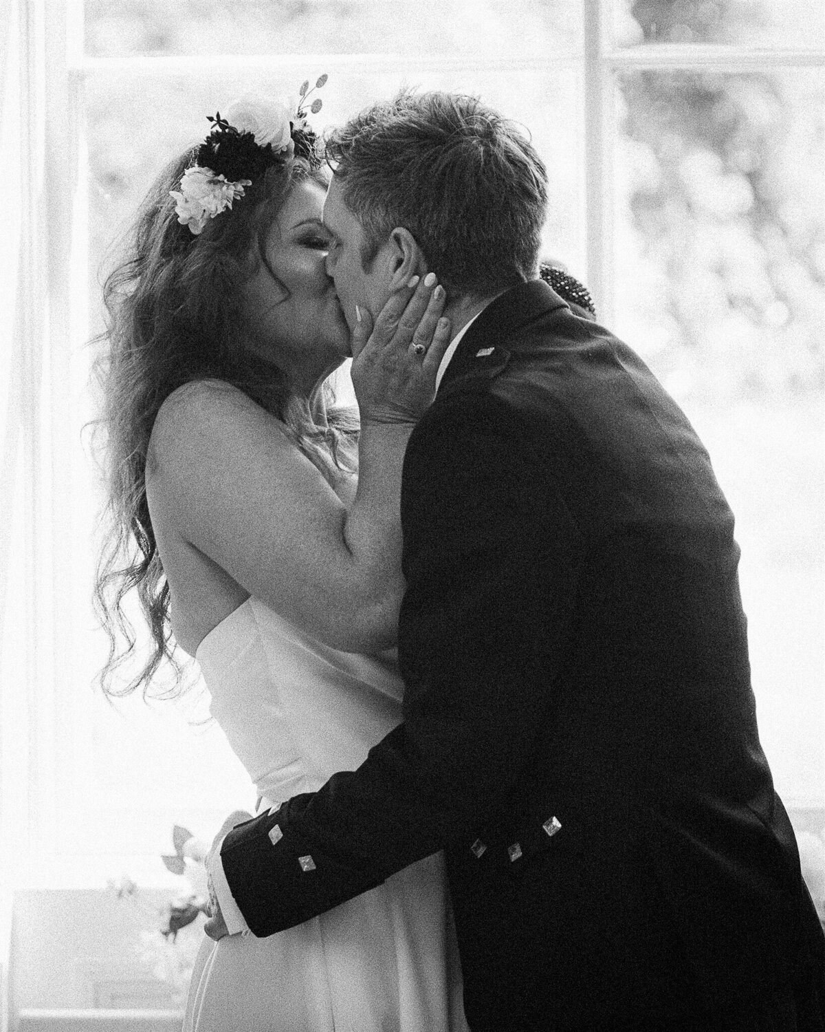 Bride and groom embrace at Netherbyres House.