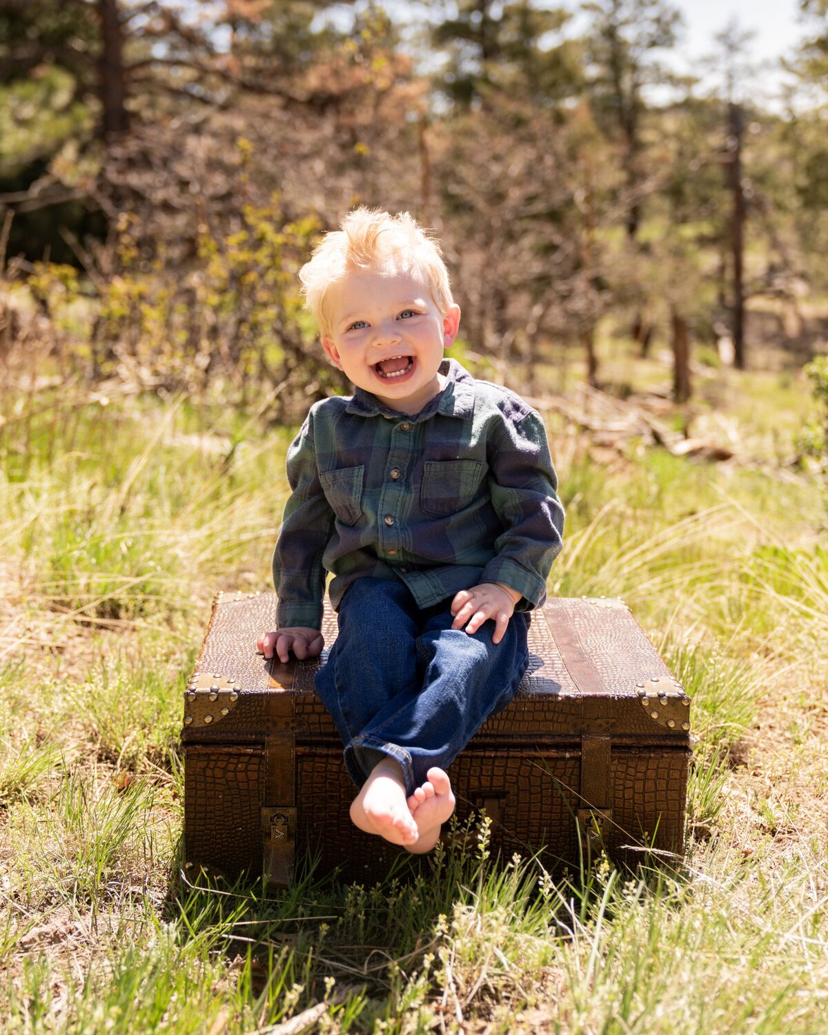 little boy sitting on wooden box