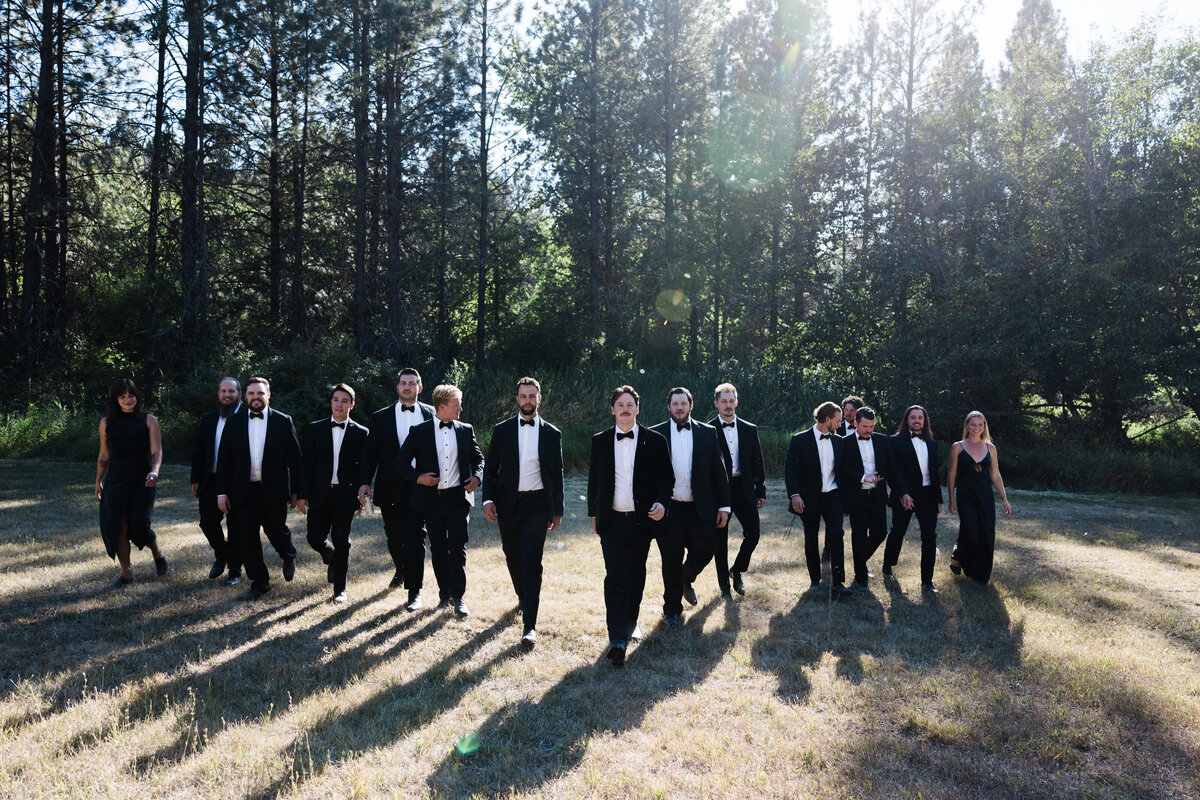 Grooms men walking along in a line at Idaho wedding