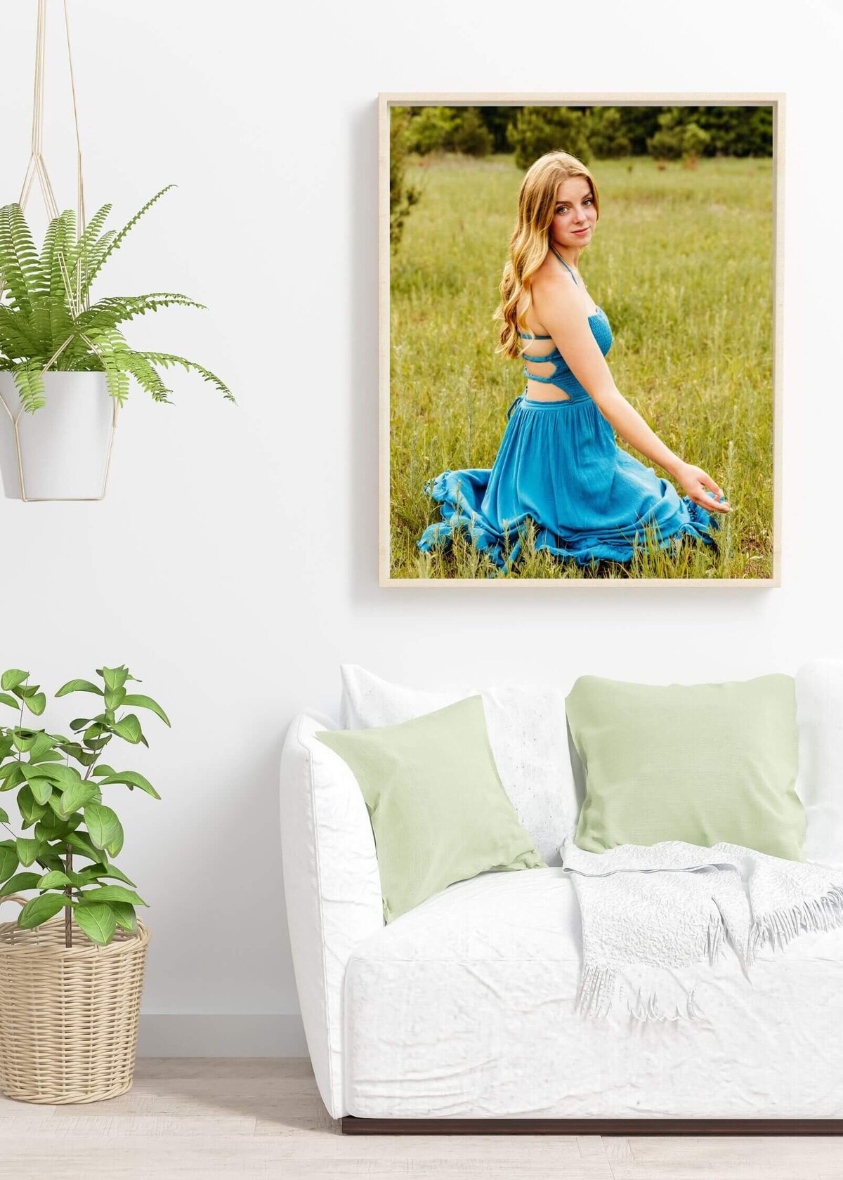 framed print of a teen girl in a teal dress hanging on a white wall in a modern living room near Green Bay