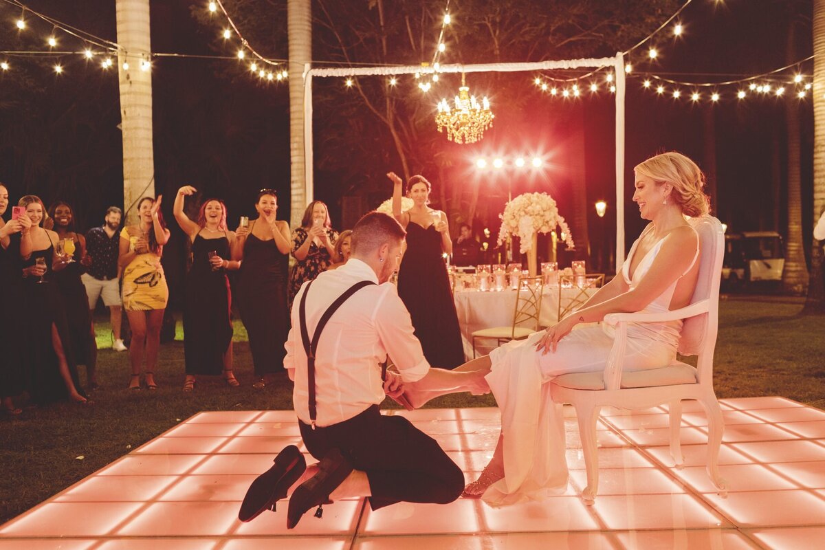 Groom removing garter at wedding in Riviera Maya