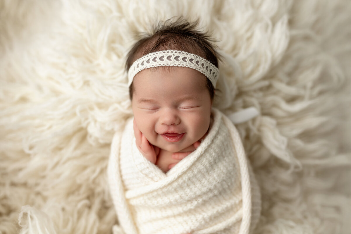 Smiling newborn at studio 