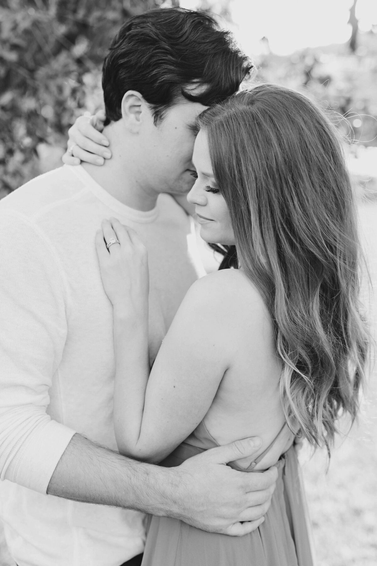 Couple holding hands and embracing at their Austin engagement session