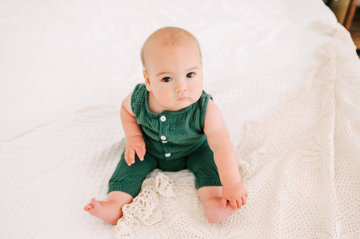 baby boy holding toes during Branson MO baby photography session