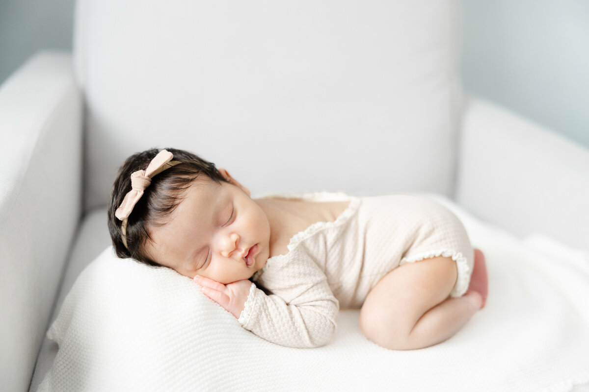 Sleeping newborn baby girl on chair in nursery by DC newborn Photographer