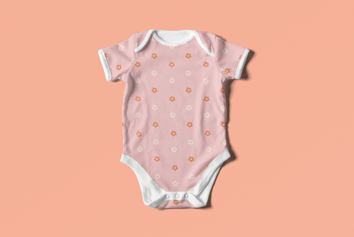 mockup-of-a-baby-onesie-lying-flat-on-a-colored-surface-4584-el1