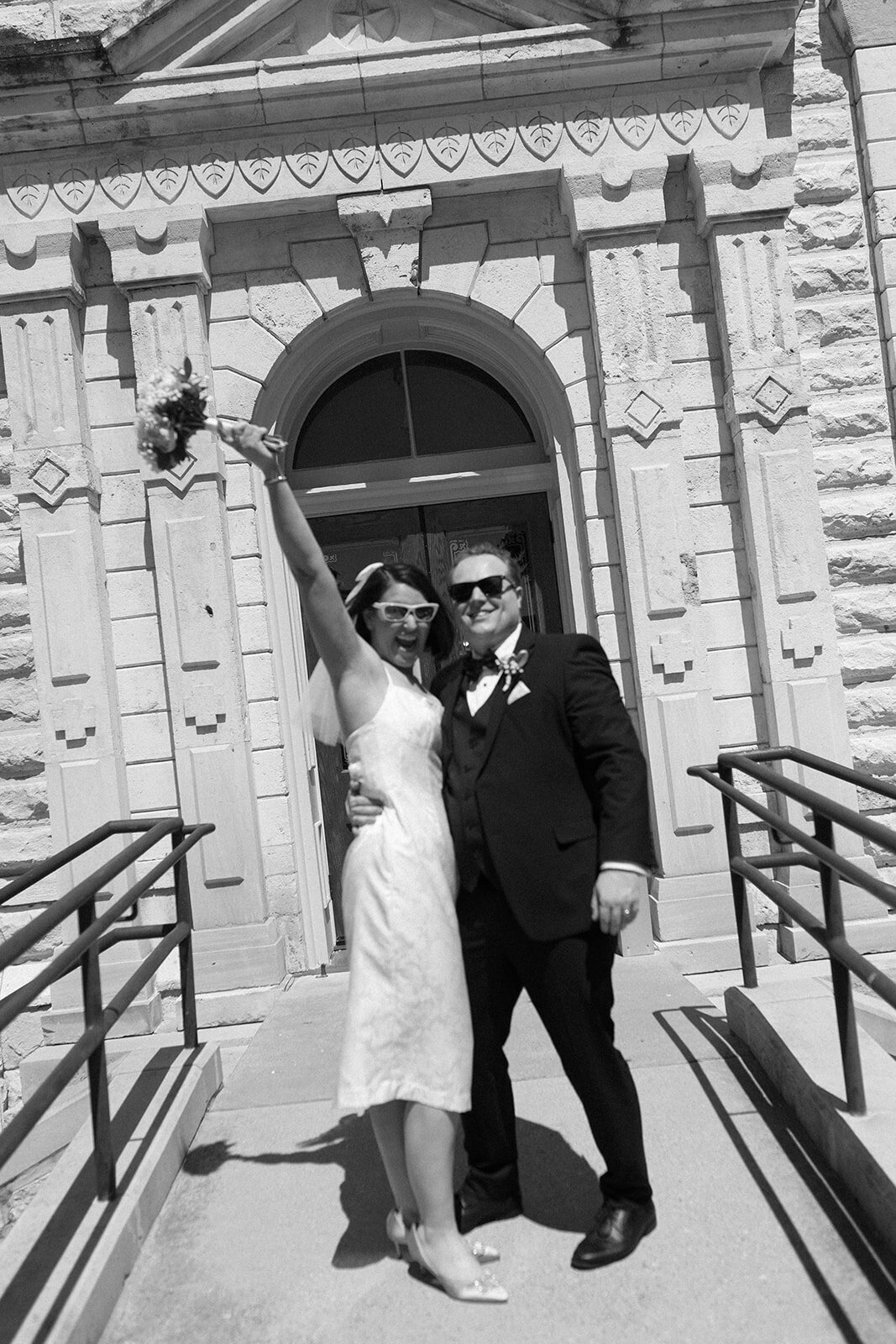Just married couple posing for a portrait at Fort Worth courthouse.