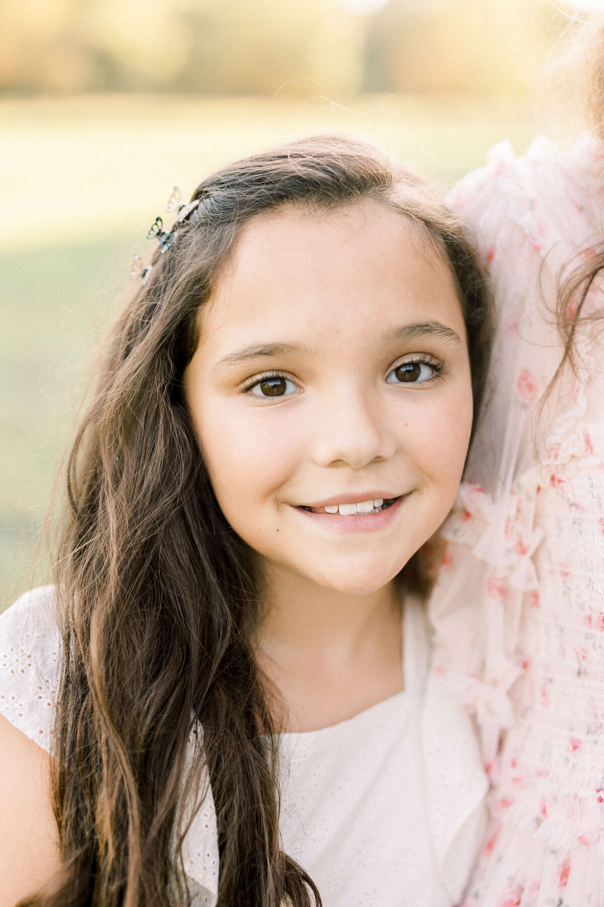 a portrait of a young girl smiling