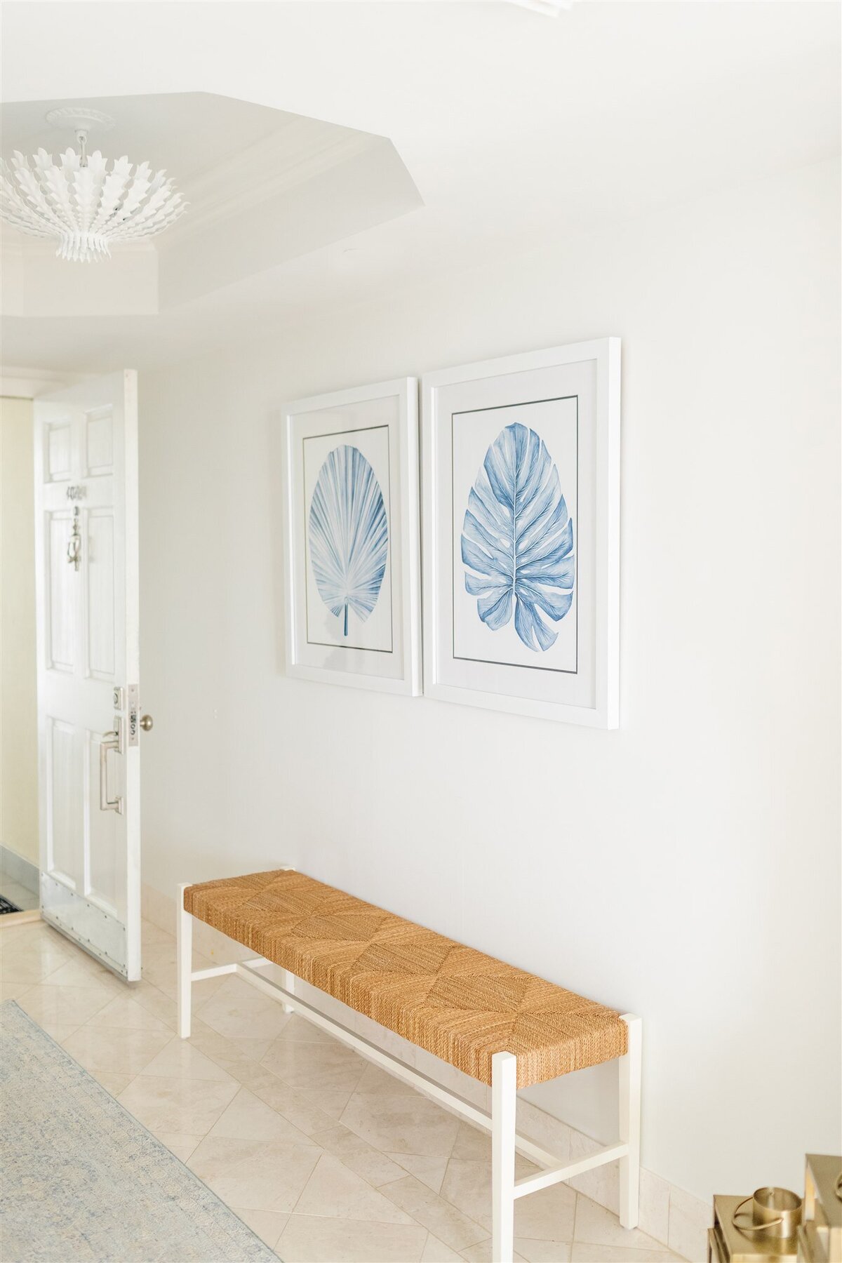 Entryway with wooden bench and coastal art