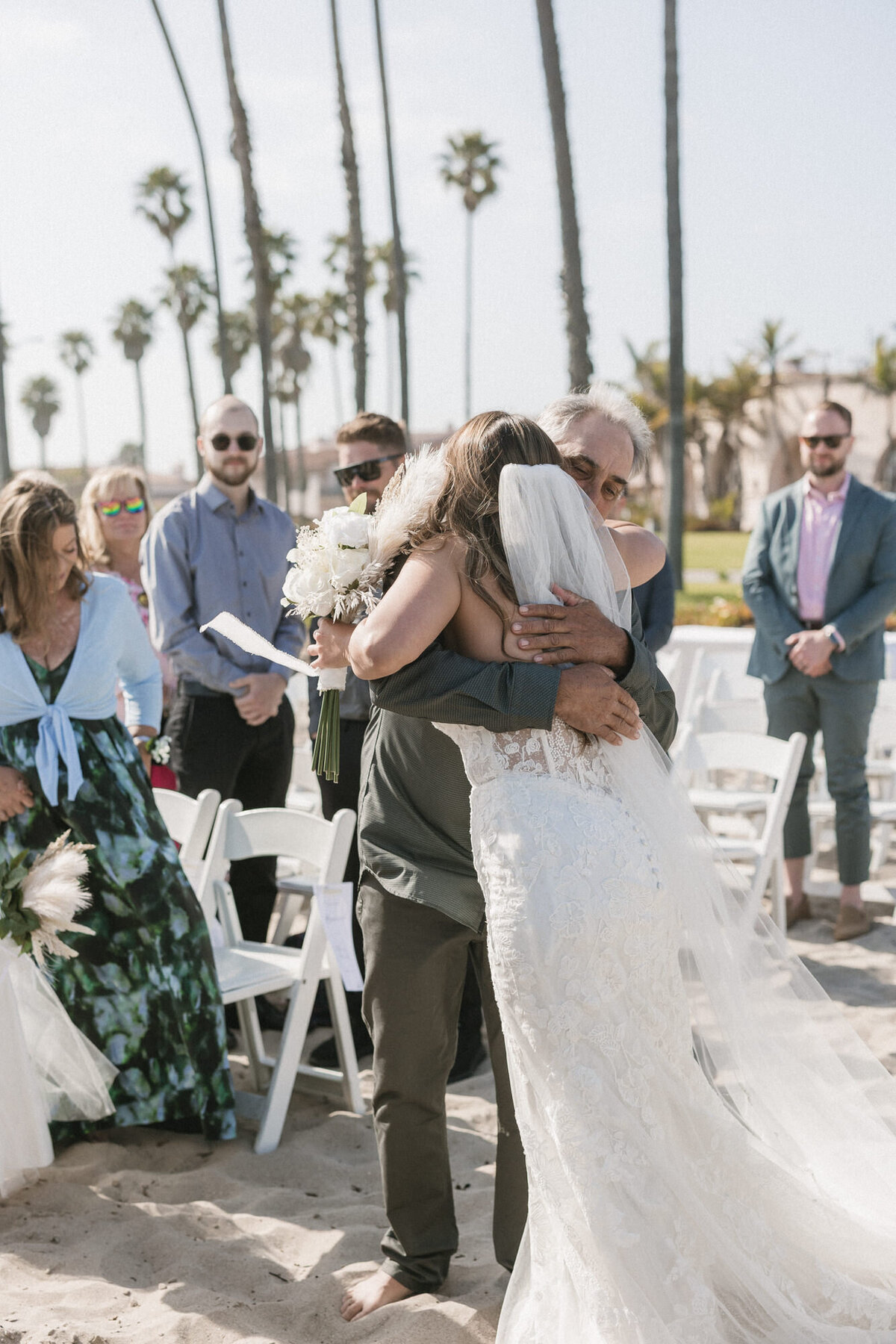 Bride and dad hugging at ceremony at Hilton Beachfront Resort Santa Barbara