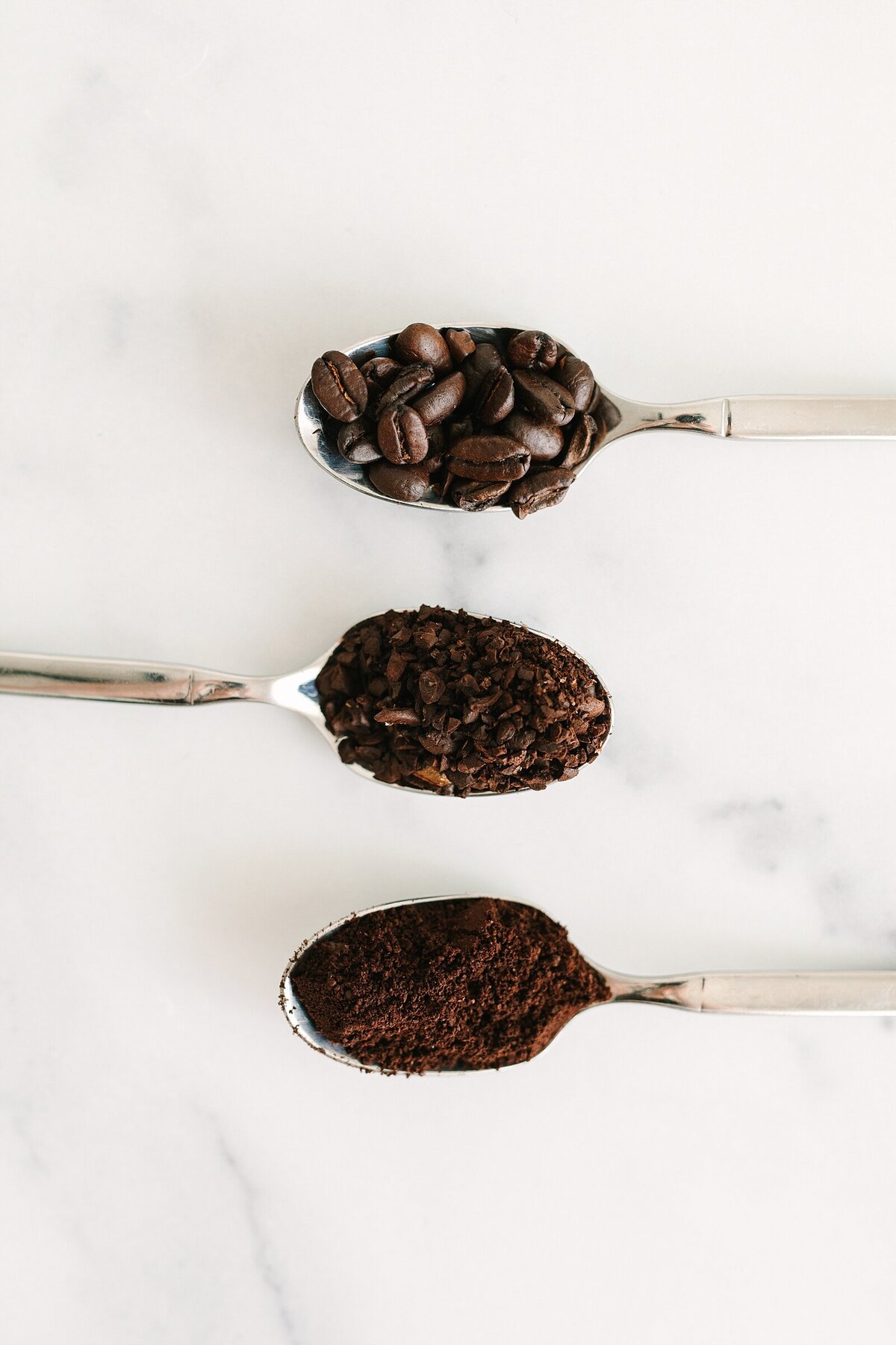 Coffee grounds on spoons at different ground levels product photography in San Diego, California.