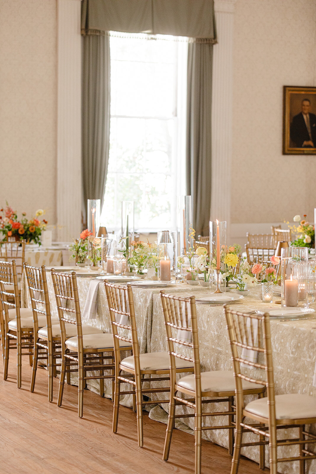 Orange florals and table decor at wedding reception at Hibernian Hall; Charleston, South Carolina