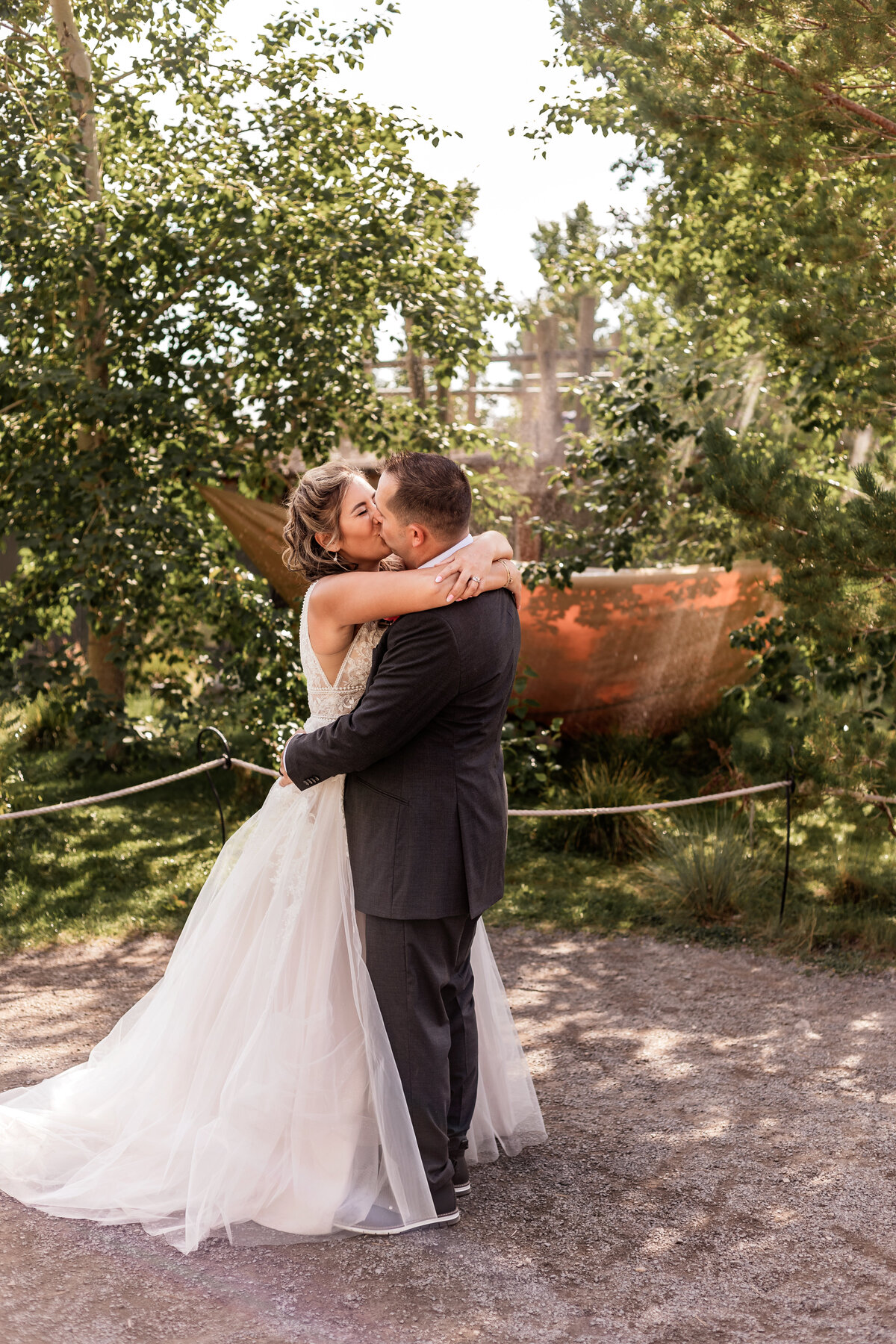 Bride and groom embrace and hug at the Land of the Lemurs at the Calgary Zoo
