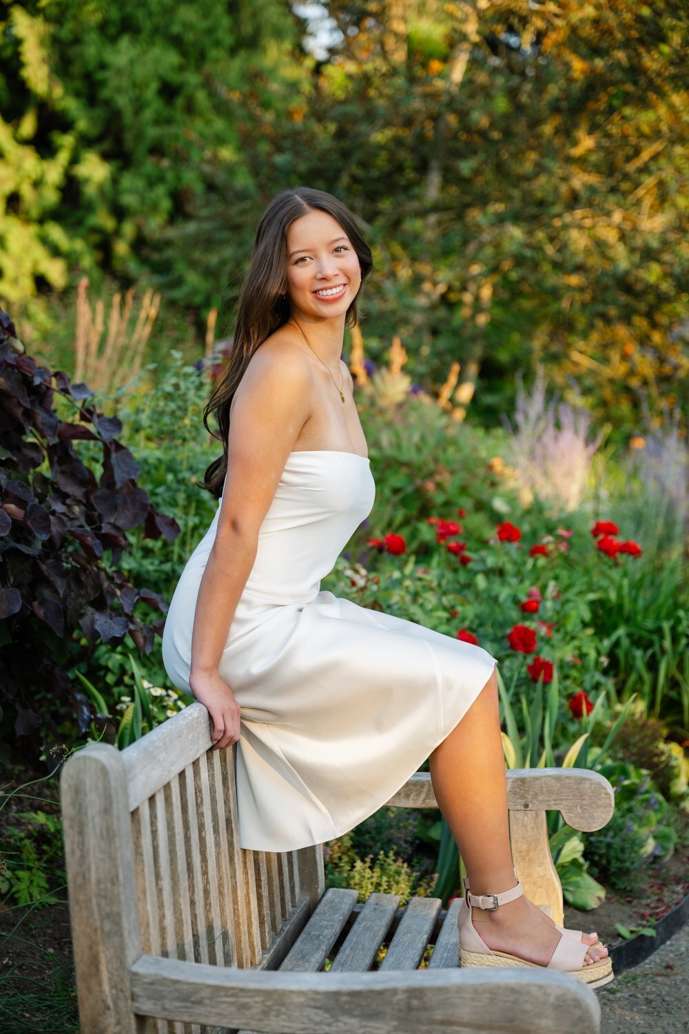 bellevue botanical garden senior on bench in formal white dress