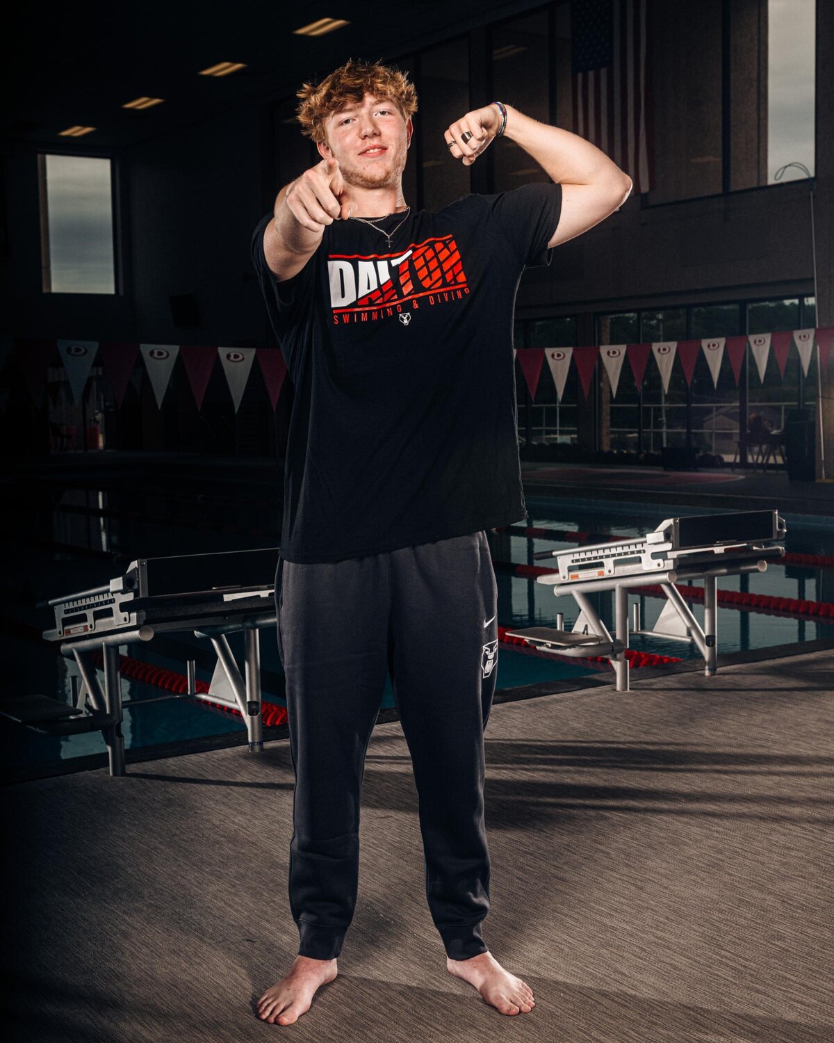 Senior Swimmer Flexing and Pointing at Camera