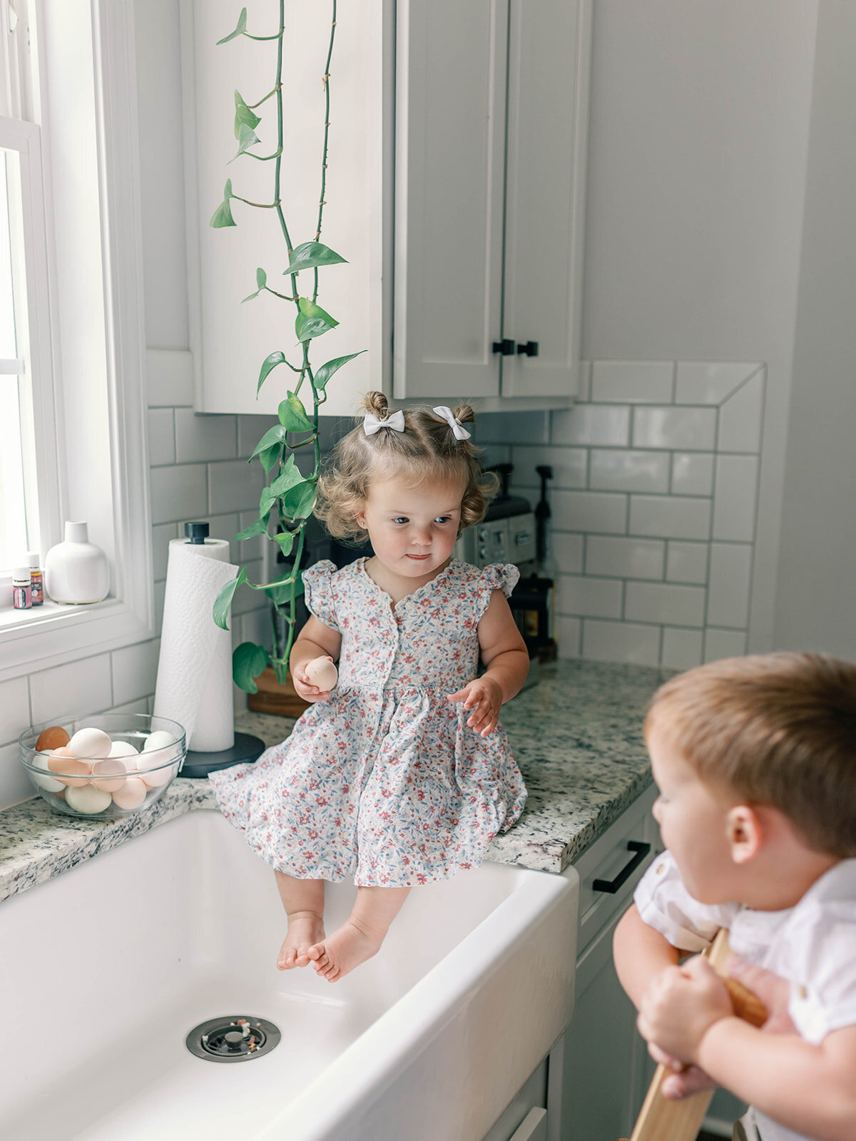 Brother and sister playing in the sink