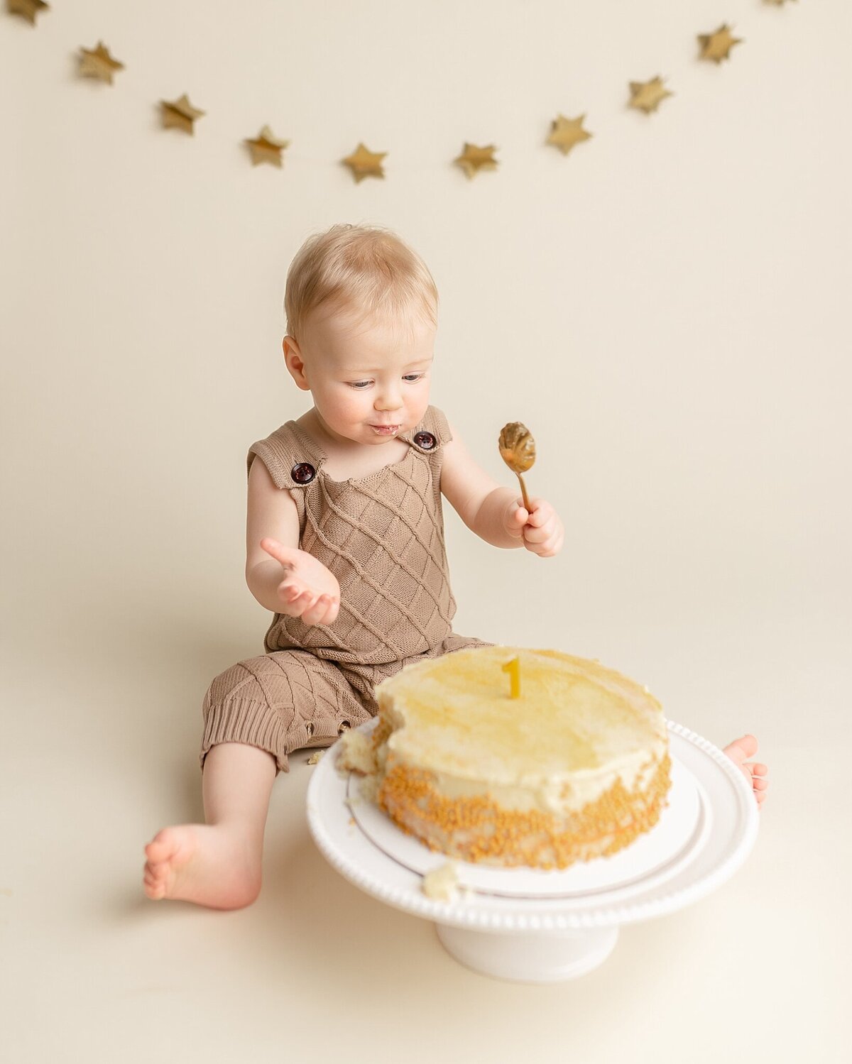 baby boy indoors in front of cake for studio portland cake smash session