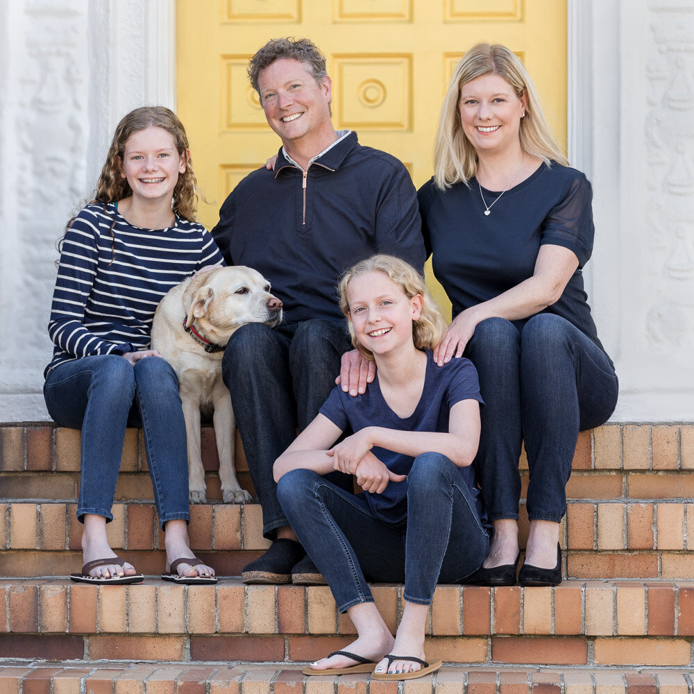family with dog on steps