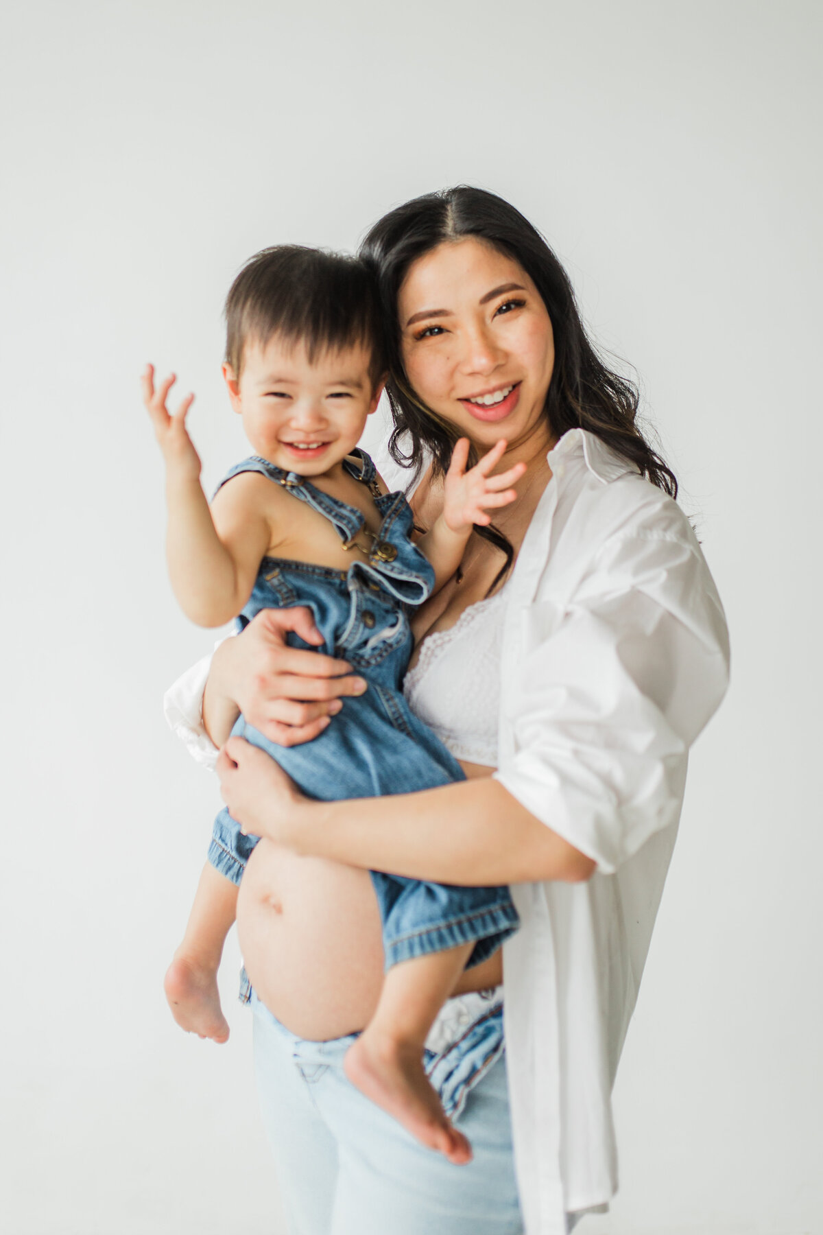 Mother holding her laughing toddler