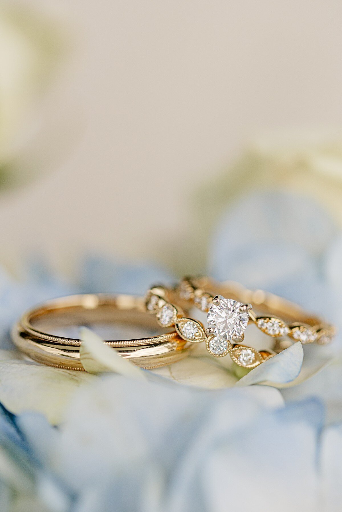 wedding-rings-stacked-on-blue-flowers