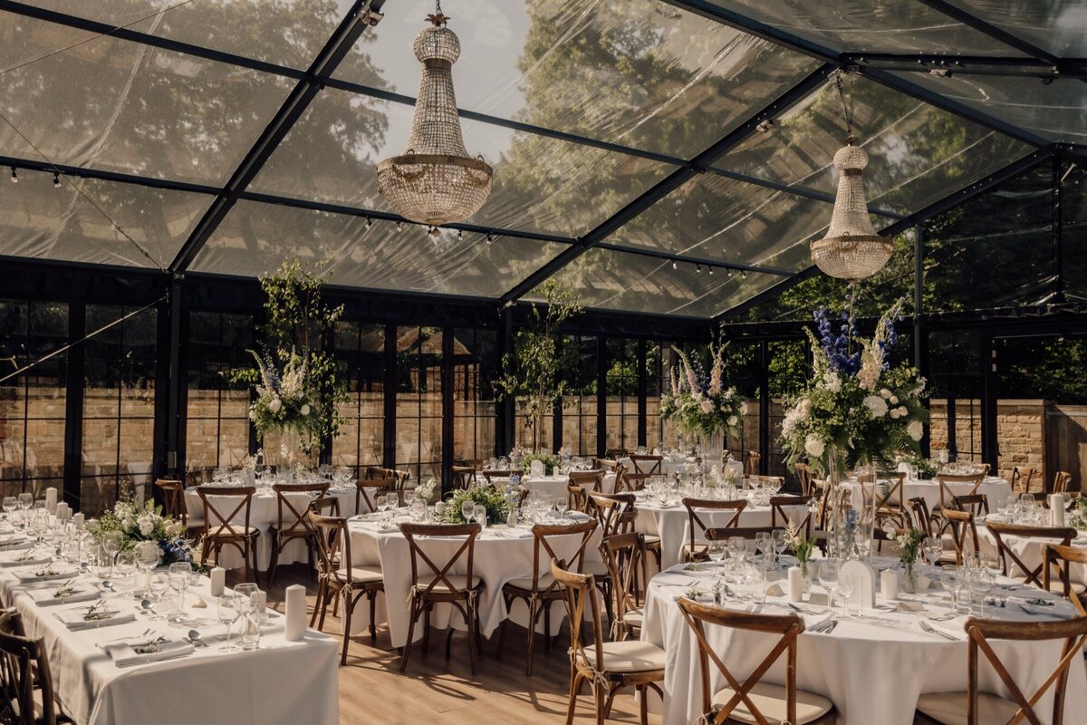 A large frame marquee with a long walkway and trees outside of the front