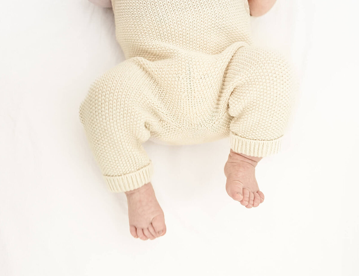 East Bay newborn photographer capturing tiny baby feet close-up during lifestyle shoot.