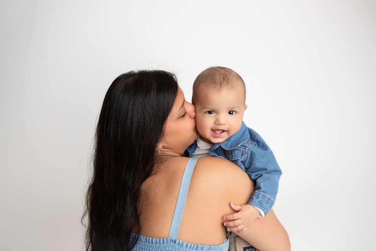 Mom and son on a simple white savage backdrop