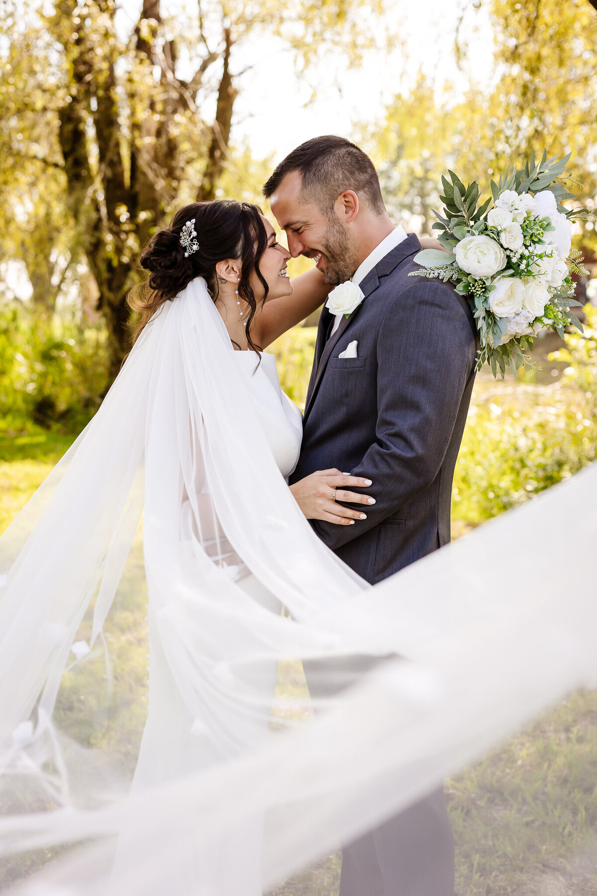 bride and groom looking into each other eyes as vail swoops across them by NH Wedding Photographer Lisa Smith Photography