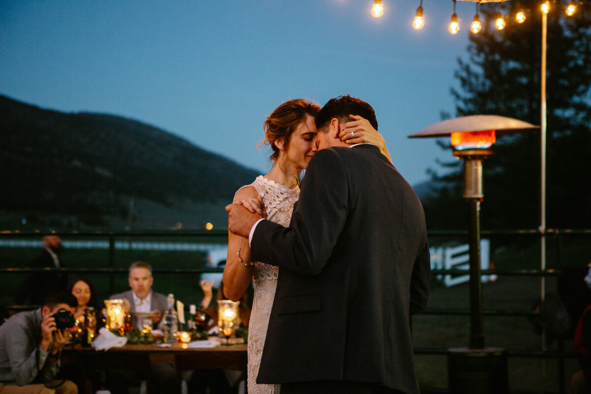 Ali and Brian slow dance under twinkle lights.