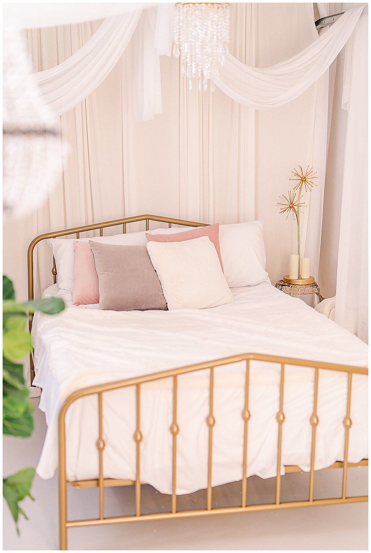 Bright and airy bedroom scene for boudoir photography with white draping