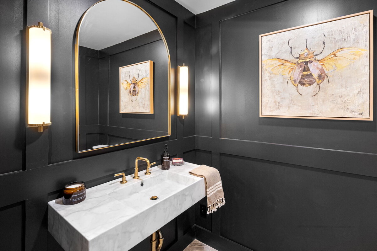 Black Bathroom with golden mirror and marble sink