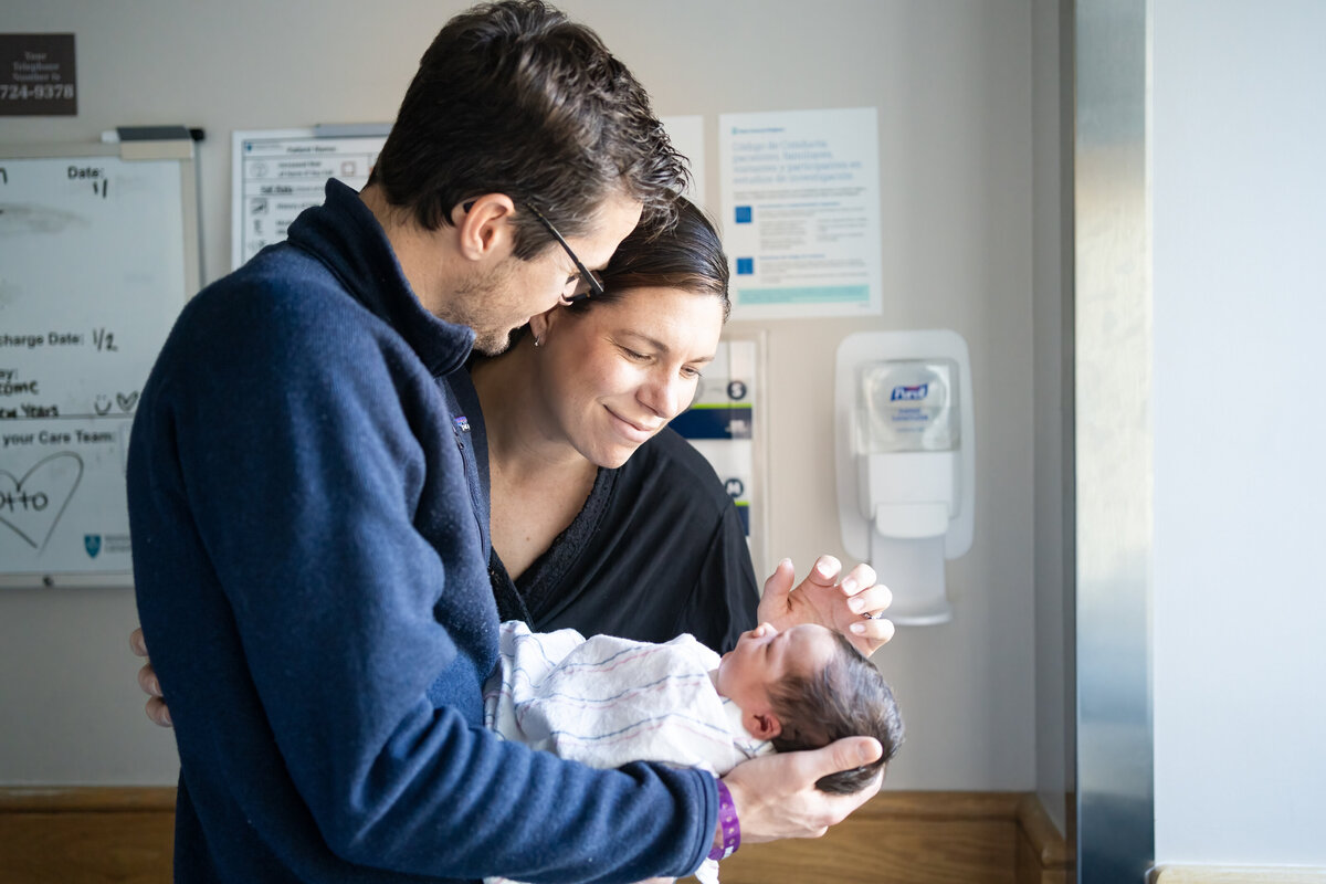Mom and dad looking at baby boy