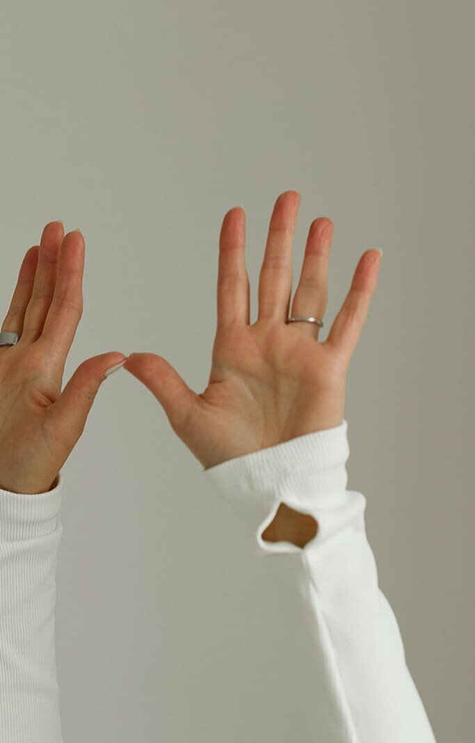 Close-up of open hands in a Kundalini mudra gesture, symbolizing energy flow and presence