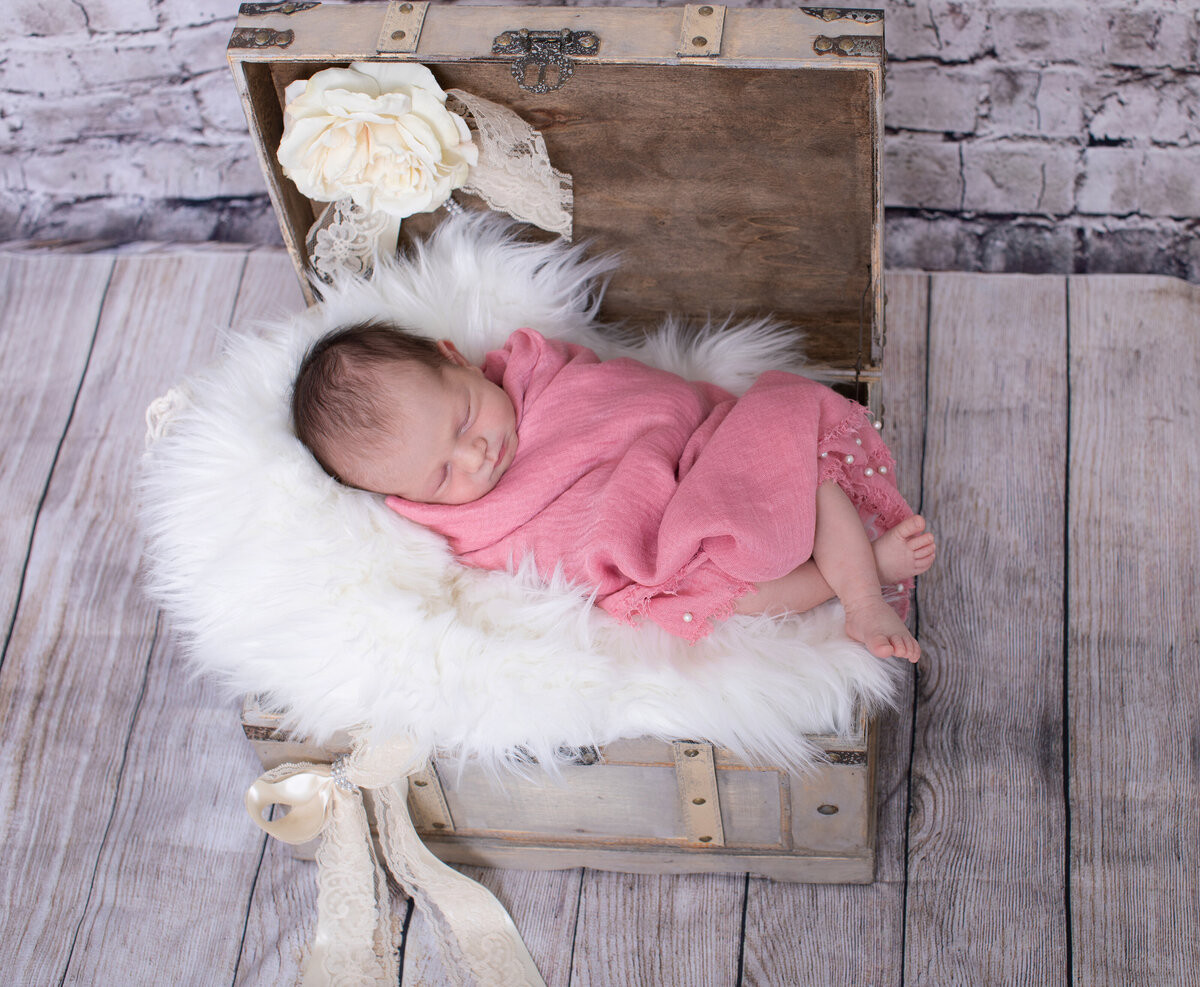 newborn session baby in chest